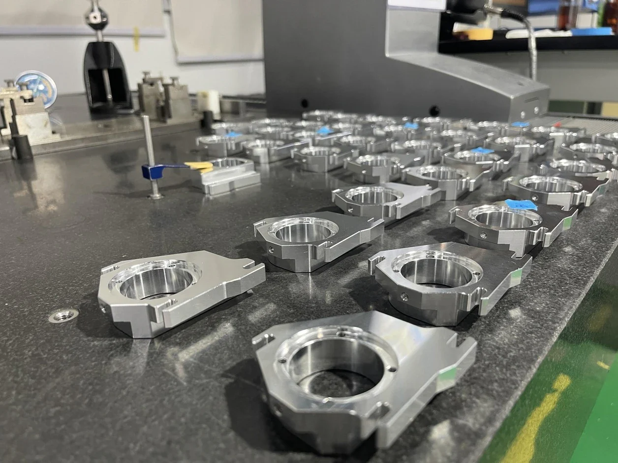Machined components staged on a workshop inspection table