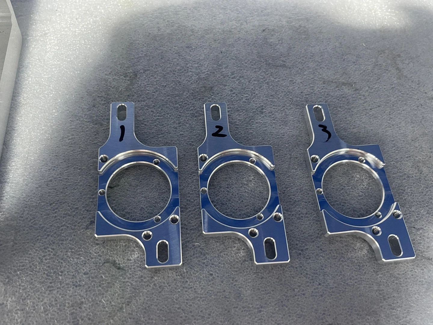 Precision anodized aluminum packaging mounting brackets with custom laser-etched QR traceability tags