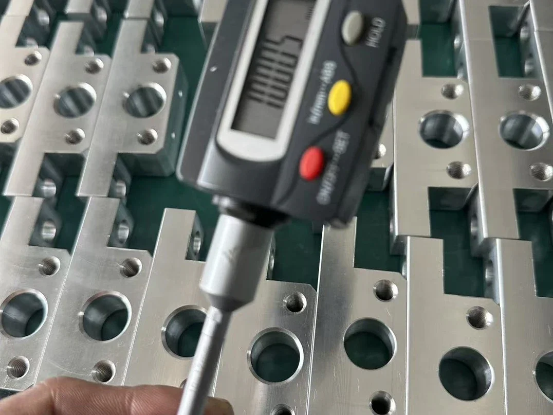 Precision machined cartoning machine parts inspected for technical compliance