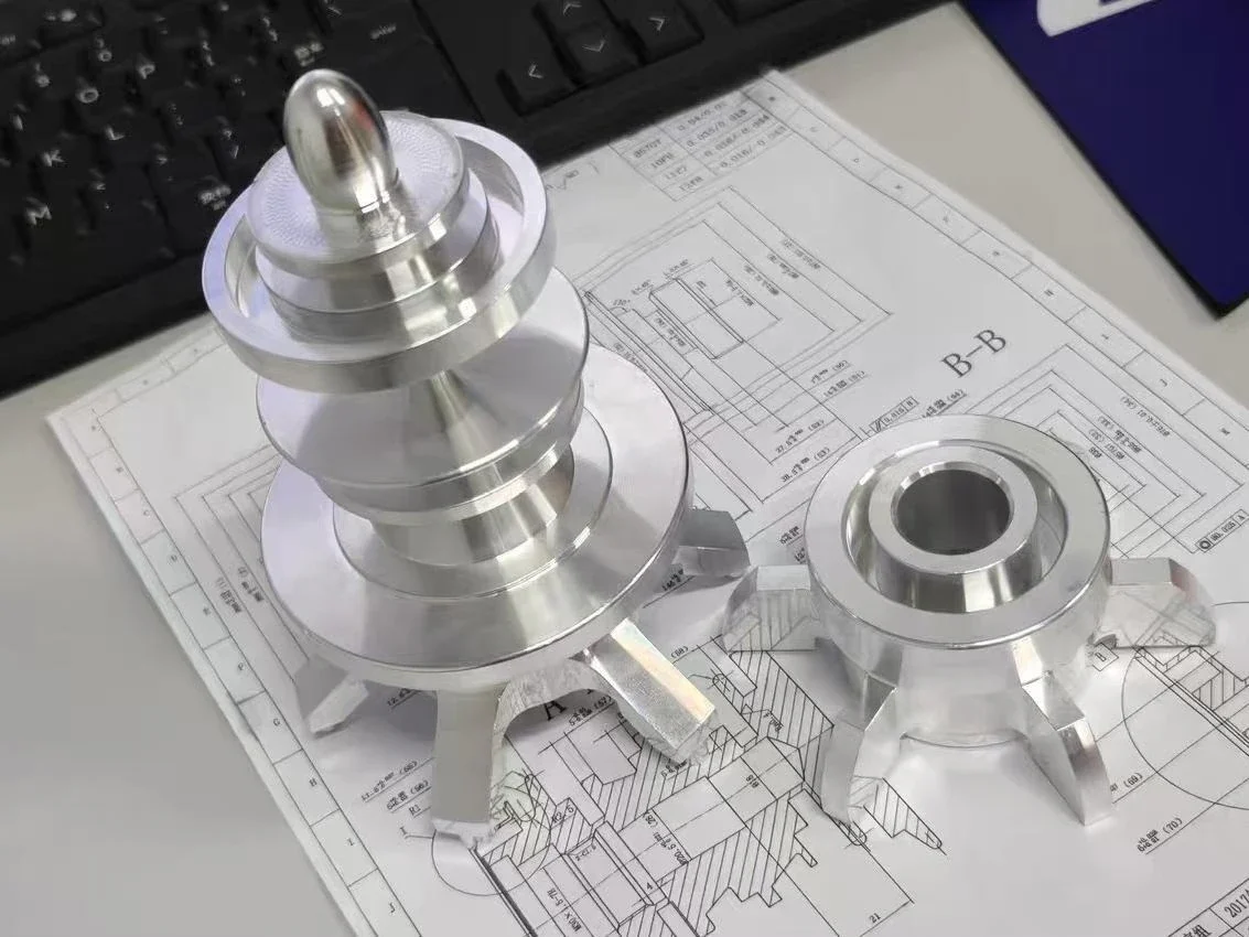 Machined component displayed with an engineering drawing for technical review
